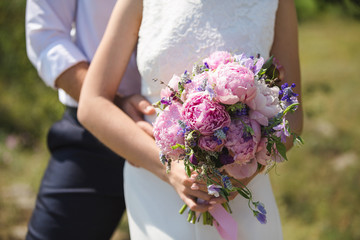 Bride and groom on the beach. Sunny, warm, the bride in a wedding dress in the style of boho, rustic.