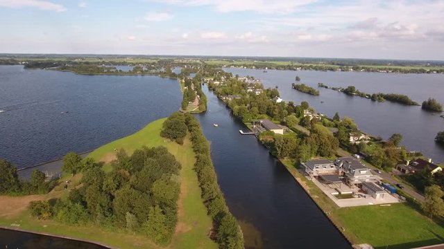 Recreational area, road and houses in lake called 'Vinkeveense Plassen' in the Netherlands. Aerial perspective.