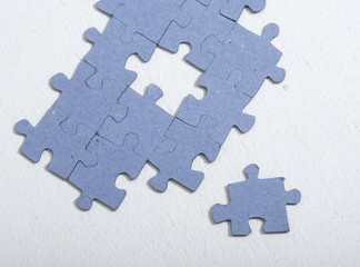 Puzzle pieces on a white table.