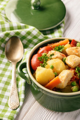 Chicken breasts stewed with vegetables (potatoes, carrots, peas, tomatoes and peppers).