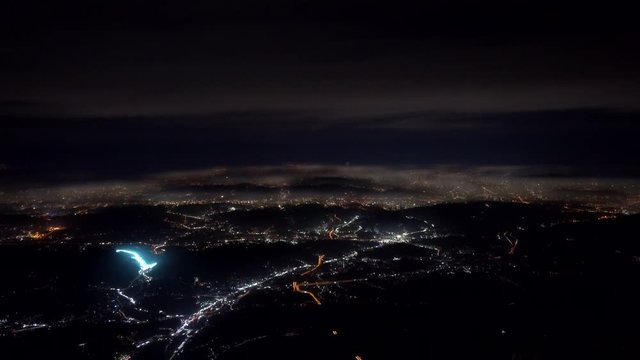 4K footage arial view of flying drone through the night light city scene