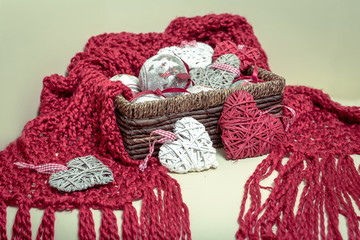 Natural Wool knitted red Scarf. Christmas Decorations in the form of balls and heart-shaped.
