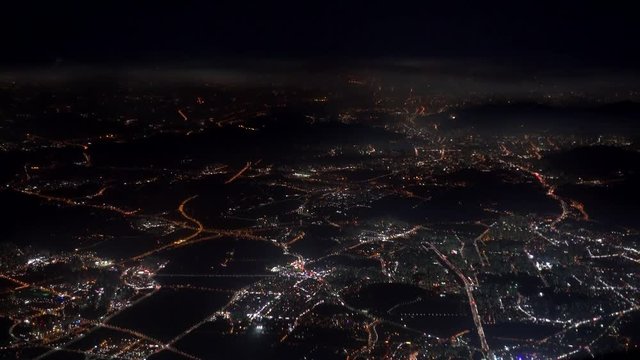 4K footage arial view of flying drone through the night light city scene