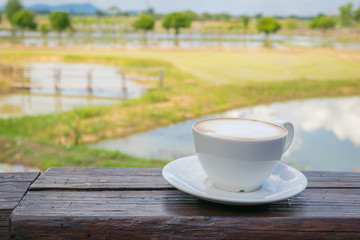 Close up white cup of Coffee, latte on the wooden table
