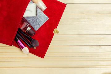 Fototapeta premium View on women bag stuff on wooden background