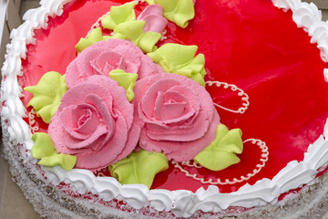 Obraz na płótnie Canvas Pink roses of cream on the cake