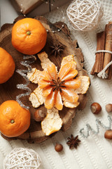 tangerines and cinnamon on the table near the Christmas tree