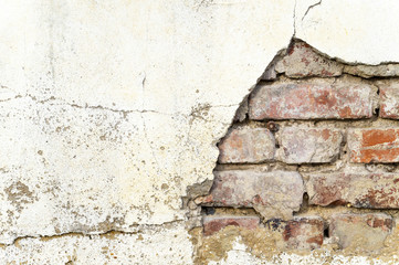 Kaputte Backsteinwand mit abgeschlagenem Putz als Hintergrund / Textfreiraum / Copyspace