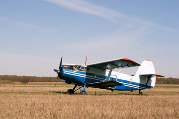 Naklejka na ściany i meble Vintage single engine biplane aircraft ready to take off