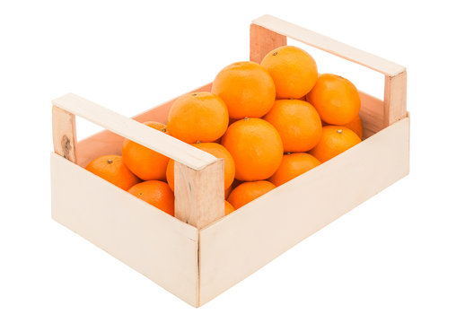 Ripe, juicy tangerines in a wooden box stacked as pyramid