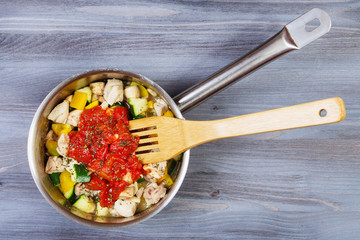 Ingredients for cooking and empty cutting board on an old wooden table. Food background with copyspace