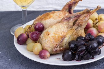 aked quails with baked grapes close-up