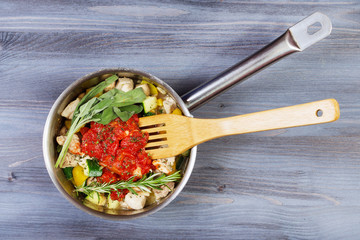 Ingredients for cooking and empty cutting board on an old wooden table. Food background with copyspace