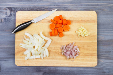 Wooden spoon and ingredients on dark background. Vegetarian food, health or cooking concept
