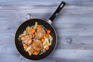 Ingredients for cooking and empty cutting board on an old wooden table. Food background with copyspace