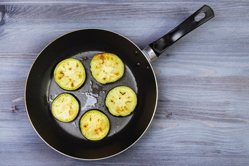 Ingredients for cooking and empty cutting board on an old wooden table. Food background with copyspace