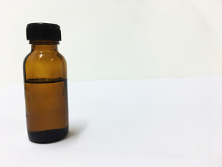 Amber bottle with the lid tightly closed on a white background