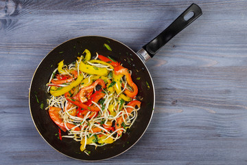 Ingredients for cooking and empty cutting board on an old wooden table. Food background with copyspace
