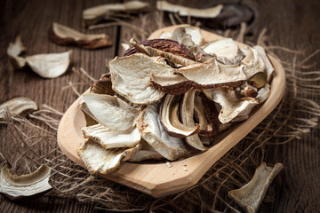 Dried mushrooms in wooden bowl.