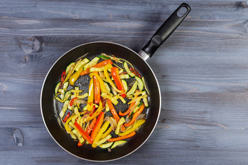 Ingredients for cooking and empty cutting board on an old wooden table. Food background with copyspace