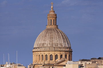 Fototapeta na wymiar The church dome overlooking the city in Malta