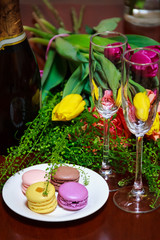 Macaroons on a plate with a bunch of flowers