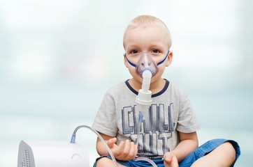 Child making inhalation with mask on his face.