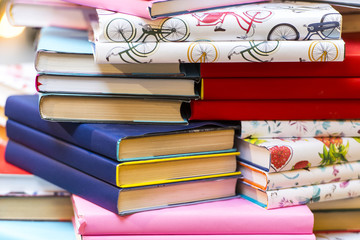 Old colorful books with dust on the table