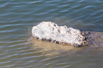 a large rock in the lake water