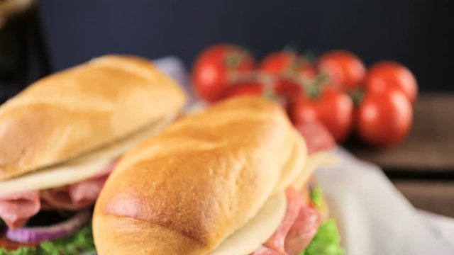 Sub sandwich with fresh vegetables, lunch meat and cheese on hoagie roll
