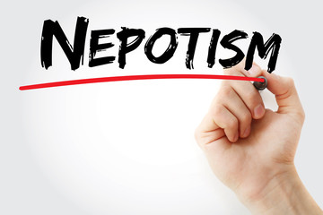 Hand writing Nepotism with marker, concept background