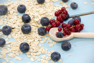 Healthy breakfast Fresh granola, muesli in bowl with milk and berries on a white background