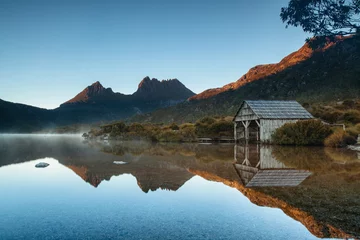 Washable wall murals Cradle Mountain Early morning light illuminates mountain peaks reflecting in the