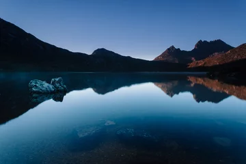 Washable wall murals Cradle Mountain Early morning light illuminates mountain peaks reflecting in the