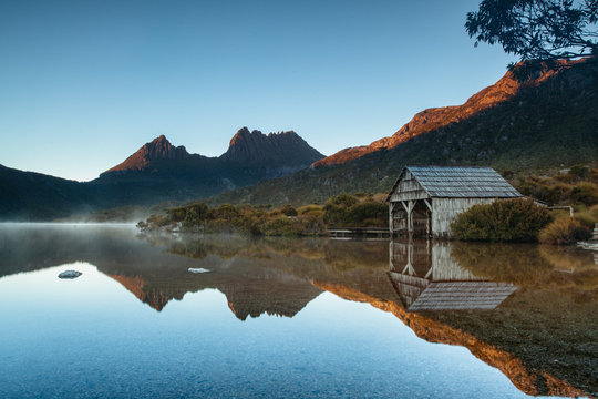 Early morning light illuminates mountain peaks reflecting in the