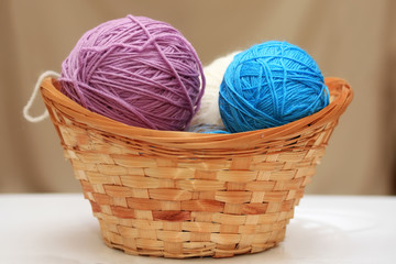 colored balls of yarn for knitting in basket