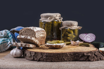 Pickles. Salted Cucumbers still-life with dark bread