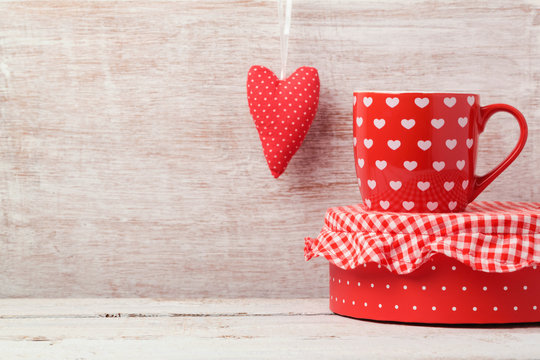 Valentine's day background with coffee cup and heart shape on wooden table