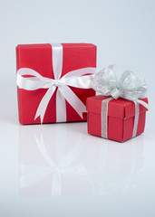 Red gift box with white ribbon isolated on white background