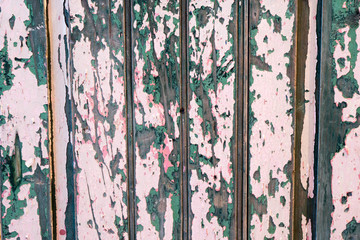 horizontal background of an old green, pink and white door