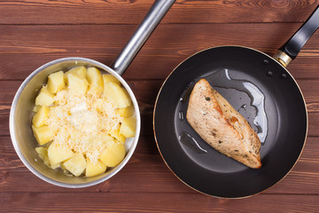 Ingredients for cooking and empty cutting board on an old wooden table. Food background with copyspace