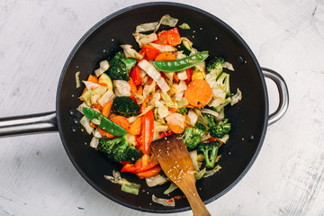 Tasty vegetable dish with broccoli and colorful peppers cooked in oil stained asian wok recipe 