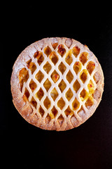 Home baked Lattice apple pie on black background