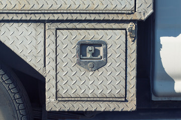 Close-up of old outdoor steel utility cover with diamond plating