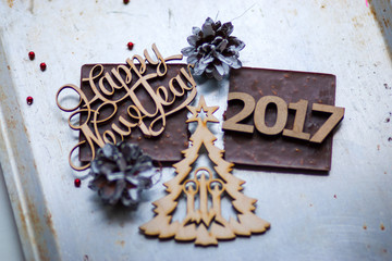 Wooden inscription Happy New Year and 2017 figures is on top of
