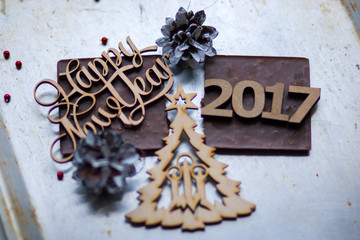 Wooden inscription Happy New Year and 2017 figures is on top of