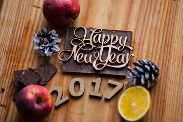 Wooden figures lying on chocolate around cones and lemon