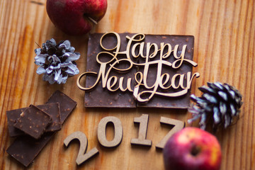 The inscription on the wooden figures lying on chocolate around