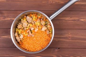 Wooden spoon and ingredients on dark background. Vegetarian food, health or cooking concept