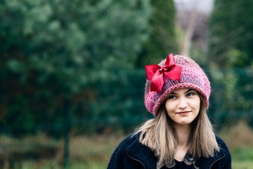 Thoughtful young woman in woolen cap